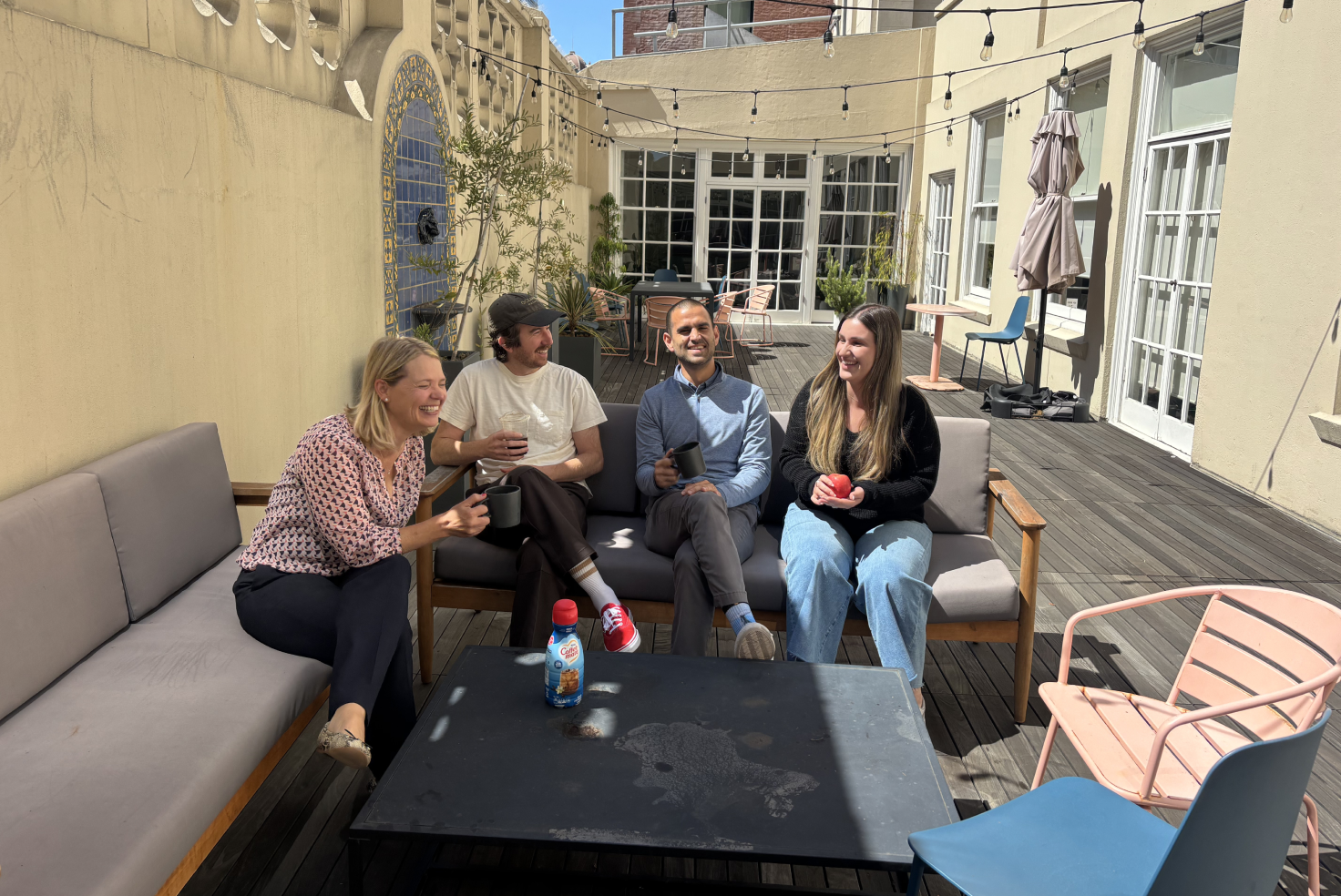 SF team members enjoying the sunshine from the office patio.